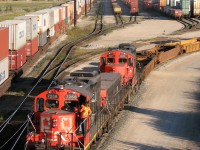 Railroading takes place in all elements: rain, sleet, snow, and sometimes when it's warm and sunny. On a warm summer evening, Canadian National GP9RM's 7268 & 7071 chug around the yard with booster slug 219, working double stacks and well cars at the north end of CN's Brampton Intermodal Terminal at Queen Street.