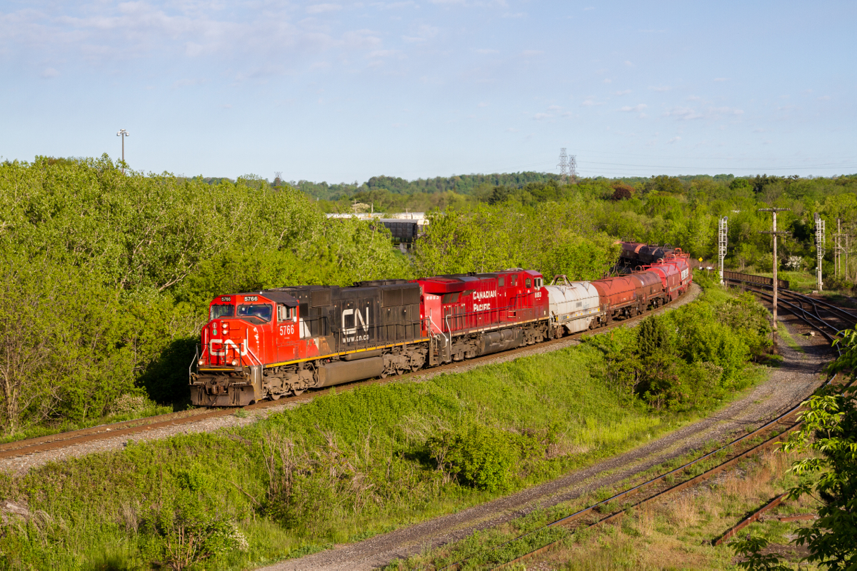 A foreign leader to the Hamilton Subdivision, CN 5766 leads Sudbury-Buffalo manifest 246 down the Niagara Escarpment on the 'Cow Path' at Hamilton West in absolutely brilliant morning light. The story behind the CN leader is that it is using up some remaining horsepower hours, none-the-less it made for something interesting to shoot and left a group of railfans standing there giddy.