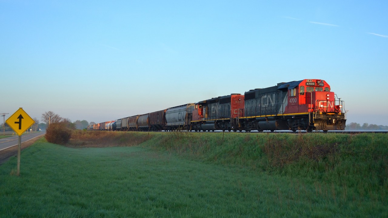 CN 438 heads eastbound into the early morning sun as it passes thru Jeannettes Creek on its daily trip to London.