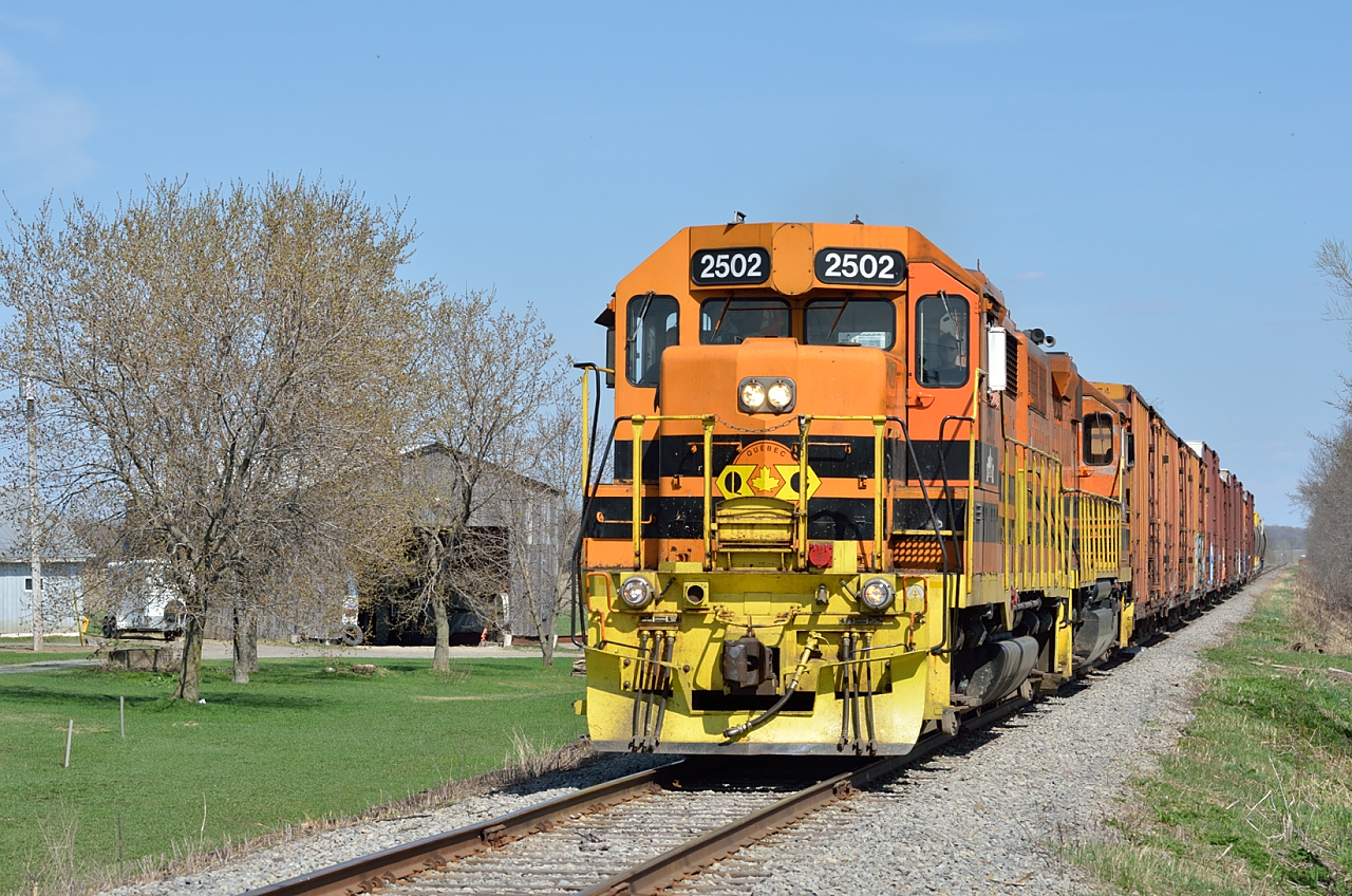 Westbound QG freight on the Lachute Sub under clear skies and summer-like temperatures.