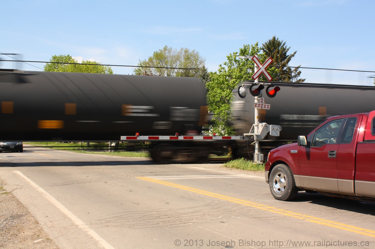 Waiting on a train… Trains move millions of tons of merchandise nationwide daily.  Have you ever stopped to think about what is going by in that boxcar on that freight train?  Or in this case what is in that tankcar.  The farmer sitting in his truck probably doesn’t realize it but the fuel that runs his truck was probably once moved by train.  Maybe the fuel in those tank cars may be what he pumps into his tank the next time he fills up his tank..