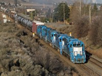Kelowna Pacific Railway’s leased GP38-2s LLPX 2605, GMTX 2641, GMTX 2258, GMTX 2632 and LLPX 2606 head east on CP Rail's Shuswap Sub.