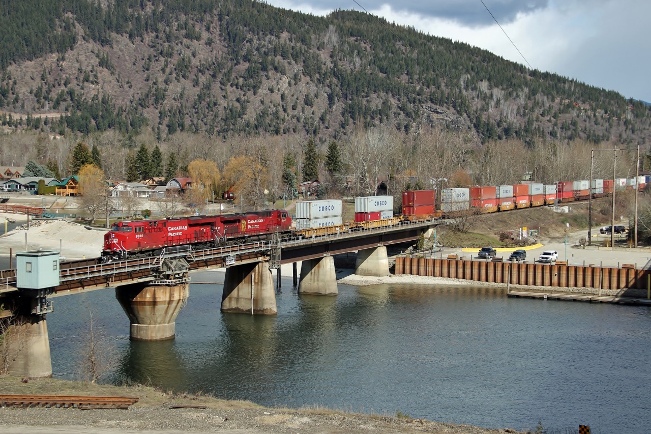 CP 9360 and 8542 lead a westbound intermodal across the swing bridge over the narrows between Shuswap and Mara Lakes.