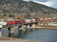 CP 9360 and 8542 lead a westbound intermodal across the swing bridge over the narrows between Shuswap and Mara Lakes.