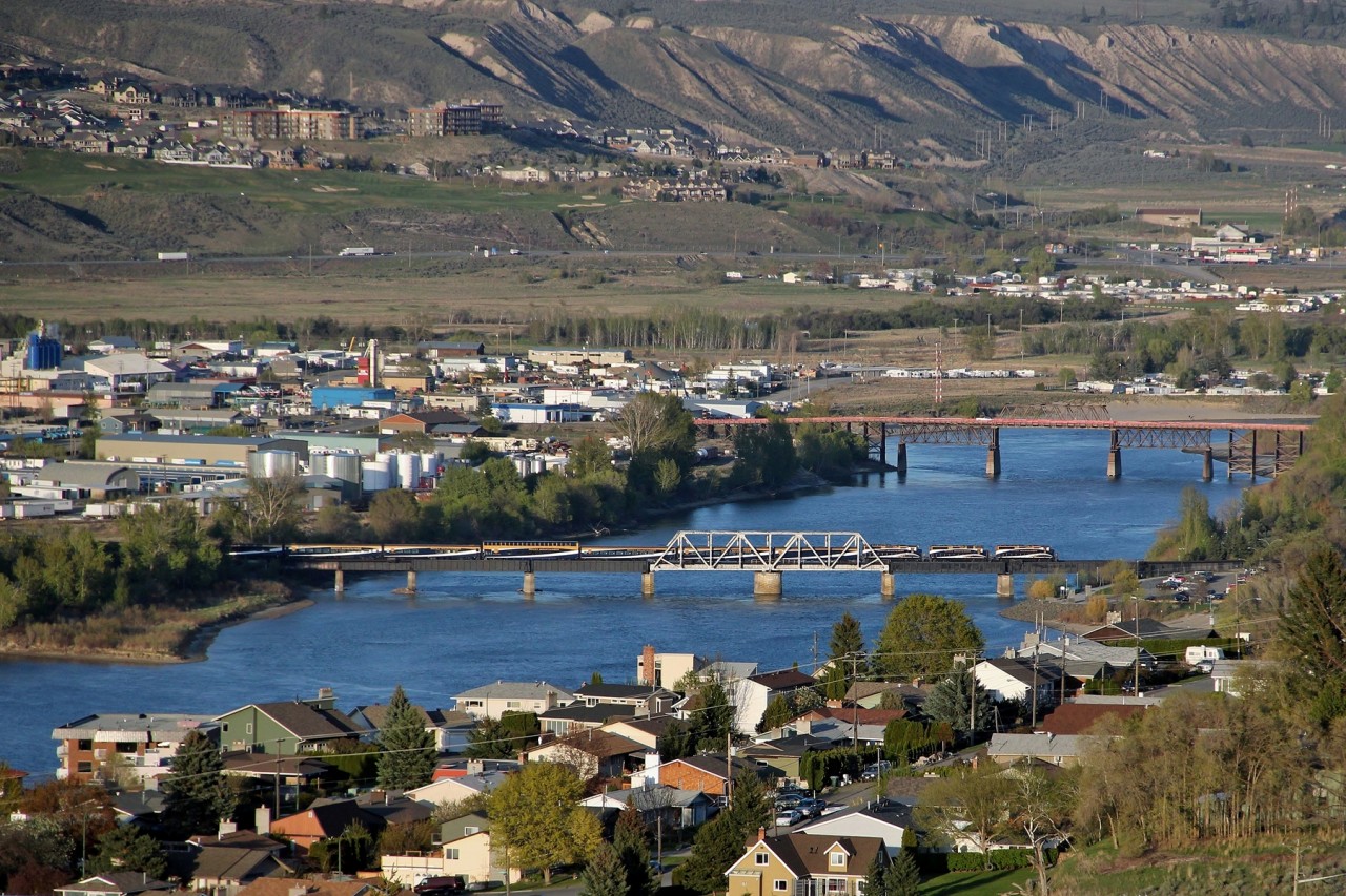 GP40-2L(W) 8011, GP40-2 8016 and GP40-2L(W) 8015 cross the South Thompson River swing bridge with the first Rocky Mountaineer of the 2013 season.