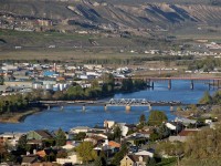 GP40-2L(W) 8011, GP40-2 8016 and GP40-2L(W) 8015 cross the South Thompson River swing bridge with the first Rocky Mountaineer of the 2013 season.