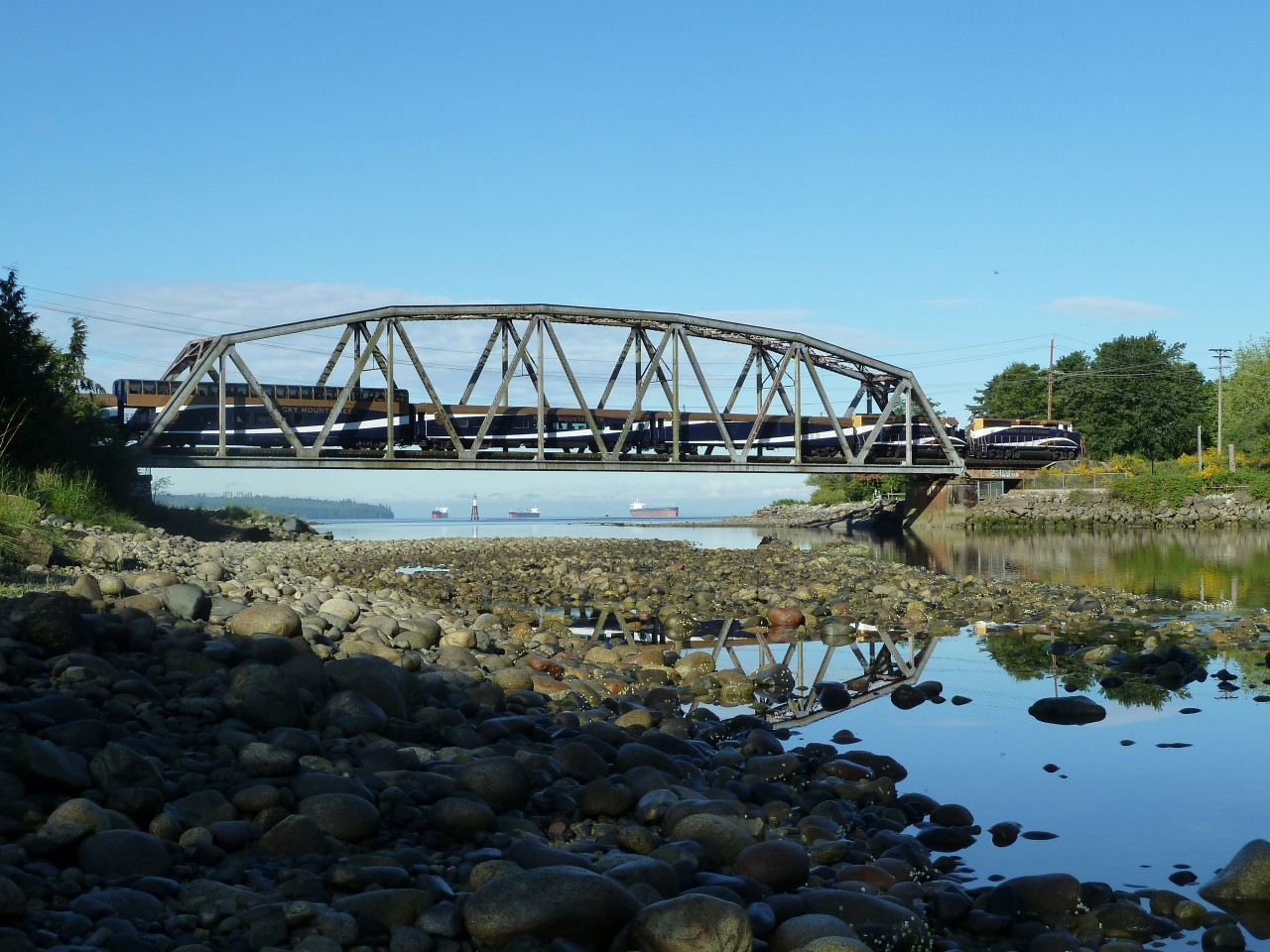 A few minutes after its 8am departure from North Vancouver, Rocky Mountaineer's Whistler Sea to Sky Climb crosses the Capilano River into West Vancouver, enroute to Whistler on a beautiful west coast morning.  
Please do not use without the photographer's permission.