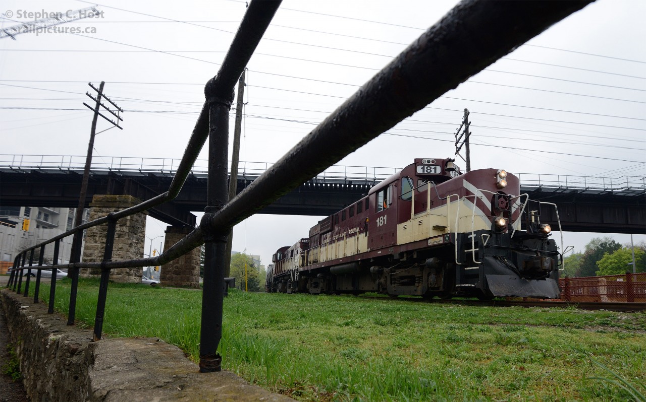 Classic MLW/Alco power is southbound on the Guelph Junction Railway - passing the many historic sites located by the 1827 founding site of Guelph - soon to be the home of towering condos in many directions. A few minutes earlier, VIA 85 passed overhead