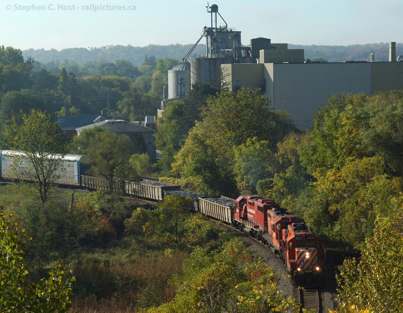 At Preston, Ontario - the daily morning Galt job is in notch 8 as they climb the mountain grade towards Hagey with the usual assortment of cars - Scrap metal from Triple Metal for the CN Interchange at South Jct, and empty autoracks for Toyota Cambridge.