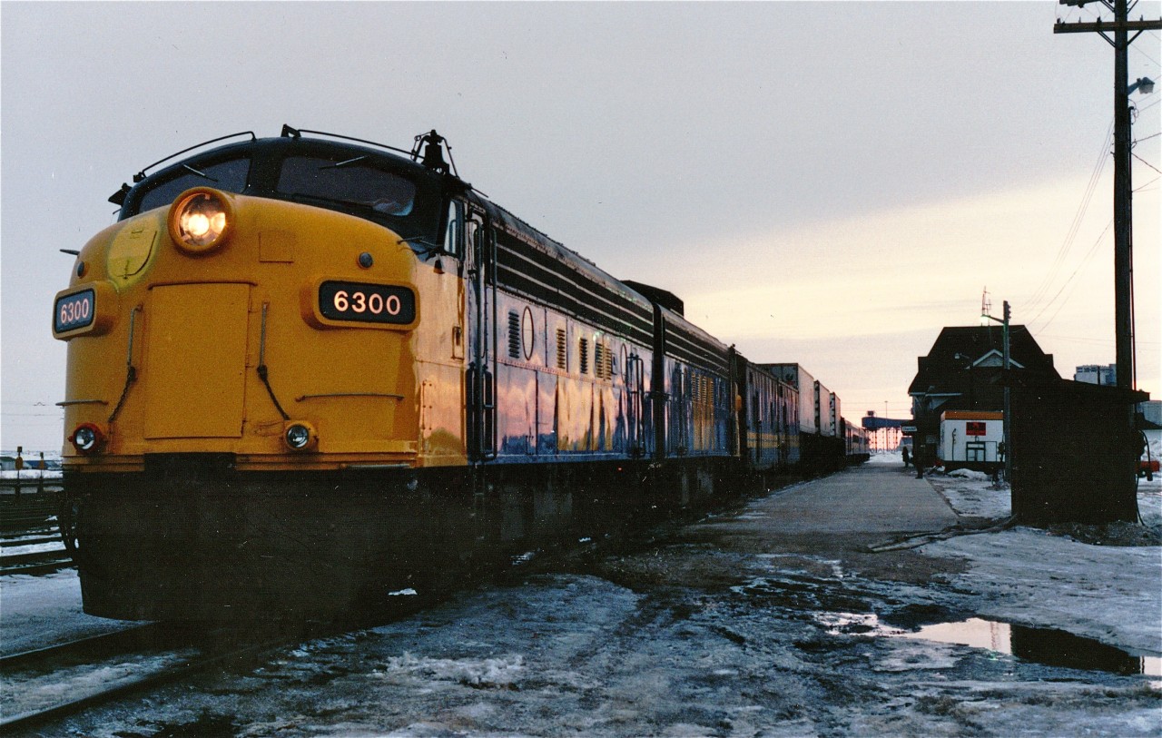 VIA Rail FP9A 6300 awaits the 9 pm departure on a Saturday evening late in April 1990 of #92 for Winnipeg, 1000 miles and 35 hours to the south.  Trailing 6300 is another FP9A, two steam generators, three flat cars each equipped with steam pass-through lines and each carrying a highway trailer, one baggage car, one coach, one dining car and one E-class sleeping car.  6300, which was badly damaged in the 1986 Hinton collision, ended its working days as the shop switcher at VIA's Vancouver Maintenance Centre.  It is now in the possession of the BC Chapter of the National Railway Historical Association, in New Westminster, BC.