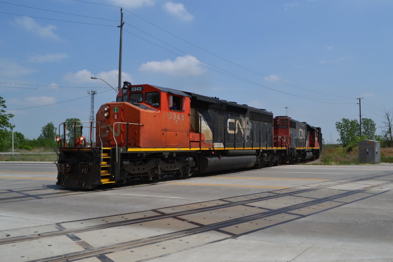 CN 439 rounds the Bend at Walker Rd in Windsor, and coming off of the CN Pelton Spur and going down the CN Caso Spur at mp 219.21. There is a set of old gondolas sitting on the former CASO Mainline waiting to be loaded with Ties that were all ripped up from the removal company of the now Abandoned portion. (here is hoping that CN or CP uses this portion of the mainline to get to some of the Factories and adds some rail to these industries in the Future.)
