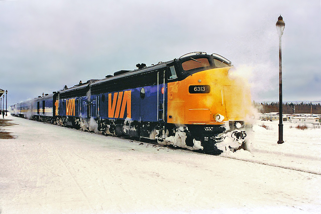VIA FP9 #6313 on the point of train 144 to Montreal, steam heated passenger cars trailing. Cochrane, ON. For more pics & video from my collection see  http://northamericabyrail.info
