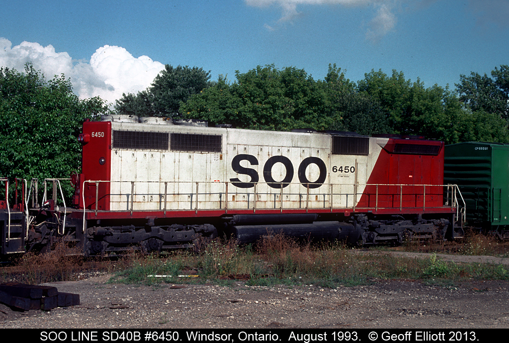 Bringing up the rear of a westbound consist in August of 1993 SOO Line SD40B #6450 does it's part to keep a 500 series train moving west.