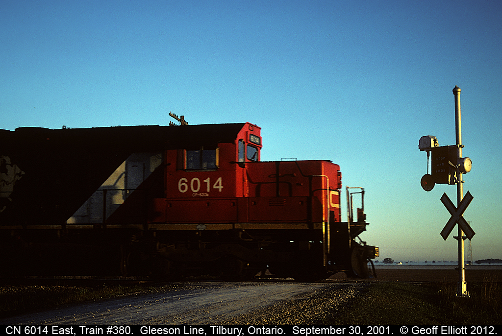 CN 6014 leads train #380 past one of the last standing 'wig-wags' in Canada on September 30, 2001.  Behind 6014 is the last rail-train to come off the Leamington Branch as CN had finished tearing up the line in the days previous.