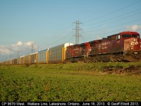 CP 9679 west approaches Wallace Line in Lakeshore, Ontario with a long train of racks on a beautiful Father's Day evening.