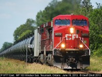 Former Lead Actor in "Unstoppable", CP 9777 leads a train of loaded oil cans east through Tecumseh, Ontario.  Note that the plow no longer carries it's stripes from the movie, having either been painted or just dirty like most CP units.