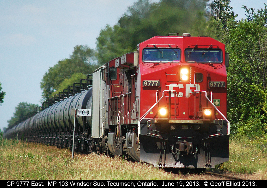 Former Lead Actor in "Unstoppable", CP 9777 leads a train of loaded oil cans east through Tecumseh, Ontario.  Note that the plow no longer carries it's stripes from the movie, having either been painted or just dirty like most CP units.