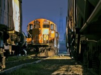 Tucked away for the morning into track A016 at Oshawa Yard, 4140 and 7046 rest after a hard nights work on 546. The power will be used later on for a beltpack yard job which services GM's Oshawa Car Plant, local customers and the building of 546's train. In the back, CN 309 pulls down the lead towards B yard for a 4 car tail end set off. Taken on CN property by a CN employee with PPE gear on. 