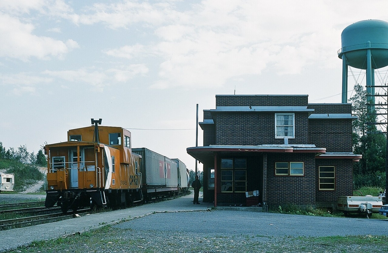 Ah....Summer North of  Superior.....when track occupancies ( blocks ) limit daylight train operations....where any operating train is a celebration....August 30 1984, Mile 63.0 Heron Bay Subdivision the former CP Rail Marathon Ontario station remains occupied as a residence as end of train device #434455 ably handles the tail end duties for CP Rail 6003 East. Note the CP Rail  COFC  ahead of the caboose. Kodachrome by S. Danko.

More Northern Ontario:

   exceptional  

   Centre of the Community  

    rare sight