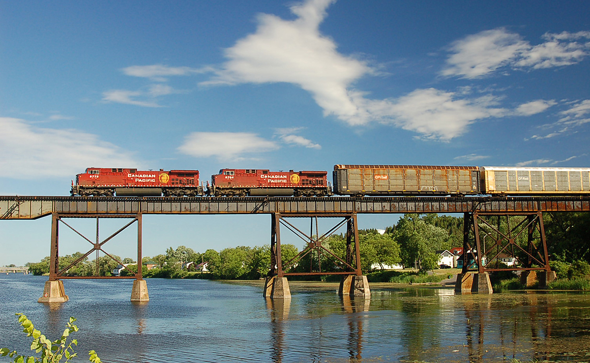 Canadian Pacific AC4400CW #9772 seems to float across the sky as it leads an eastbound freight across the trestle at Trenton, ON. For more pics & video from my collection see  http://northamericabyrail.info