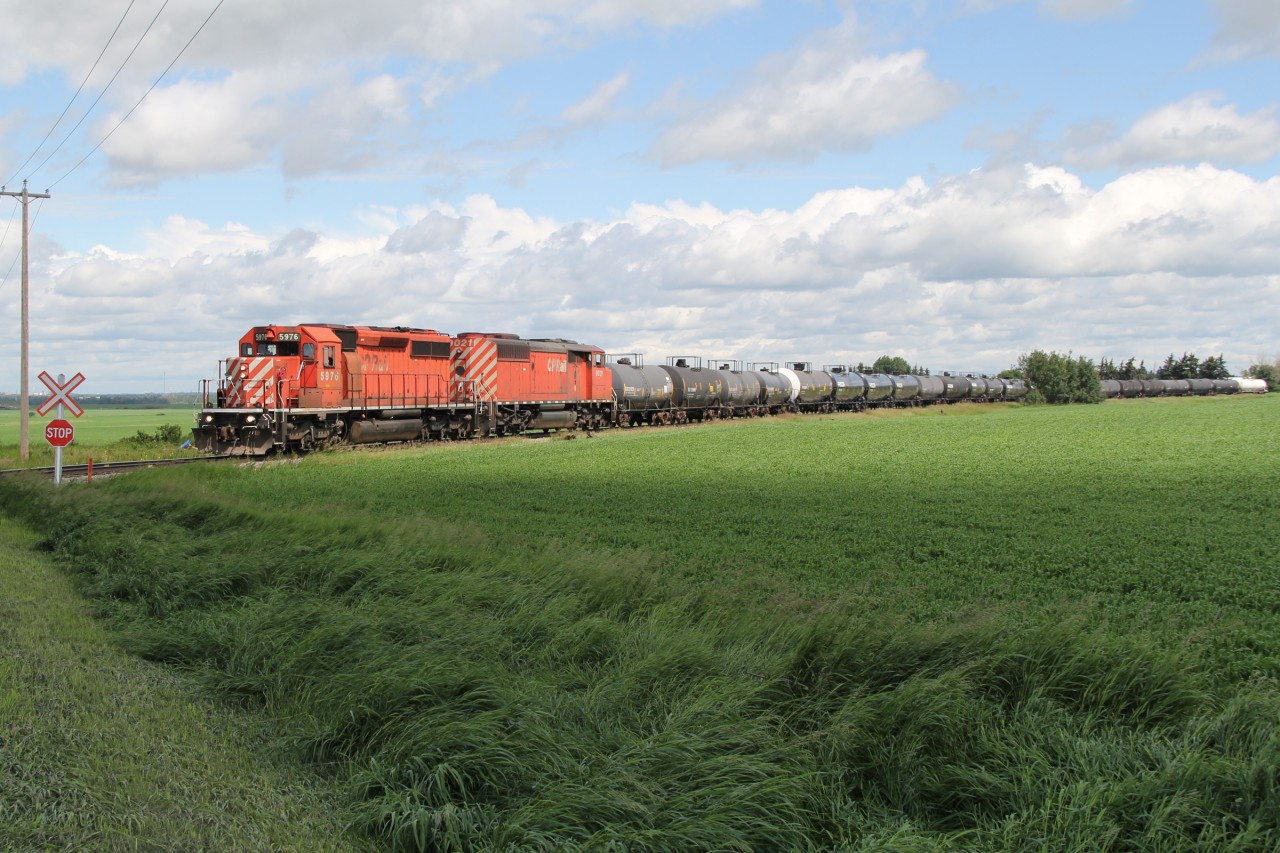 SD40-2 CP 5976 and 40-2F "Red Barn" 9021 continue their journey south approaching the RR223 grade crossing at MP 155.