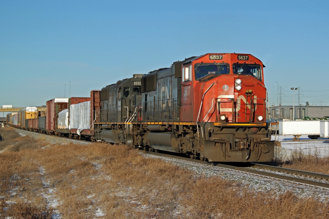 SD70I CN 5637 and SD70 IC 1011 head south on the Camrose Sub.