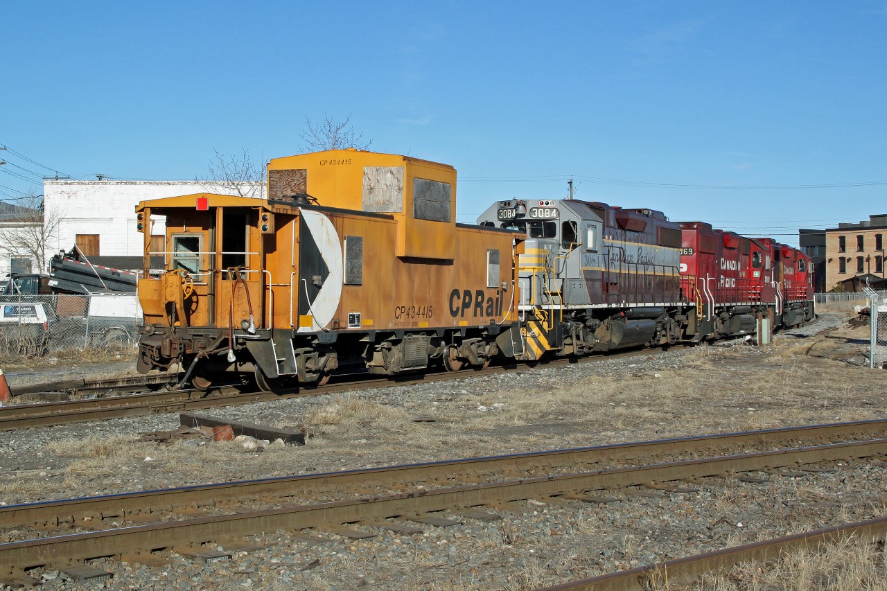 Lots of power for this caboose hop.  CP Caboose 434415 is led into town by 3 GP38-2's,  3084 in tuscan and grey heritage paint scheme and 3069 and 3082.