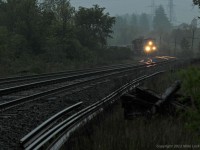 On a gloomy, rainy evening, CEFX 1020 and CP 9664 are fresh out of Agincourt with 240's train as they pass Cherrywood siding. 1844hrs.