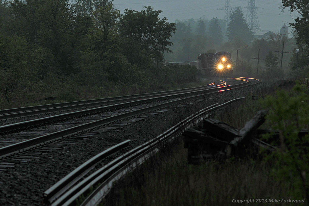 On a gloomy, rainy evening, CEFX 1020 and CP 9664 are fresh out of Agincourt with 240's train as they pass Cherrywood siding. 1844hrs.