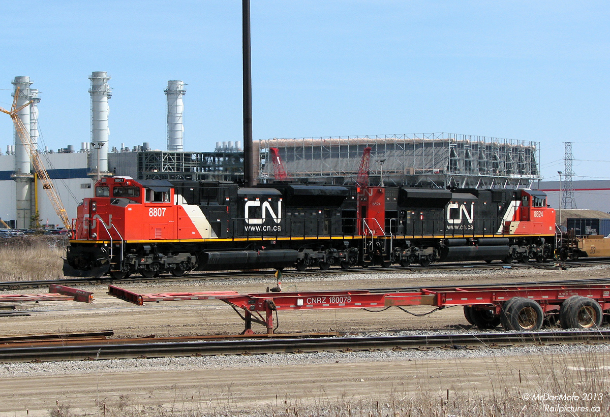More BIT action, this time featuring the newest in stylish mainline freight power (at the time): shiny CN SD70M-2 units 8807 and 8824 work the north end of the Brampton Intermodal Terminal, with just-arrived intermodal hotshot #148. In the background, the natural-gas fuelled Goreway Power Station is being constructed off Goreway Drive, its large emissions stacks already erected.
