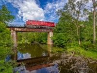 In this wide angle scene, CP 8951 thunders across the 102 year old trestle above the Bronte Creek in Progreston, ON. The town of Progreston was established around mills that were powered by the nearby waterfall. In the early 1900s Progreston had become a manufacturing centre, however, by the 1950s Progreston had deteriorated to only a handful of residences. Today Progreston remains as a hamlet, part of Carlisle and part of the even larger Hamilton Area.