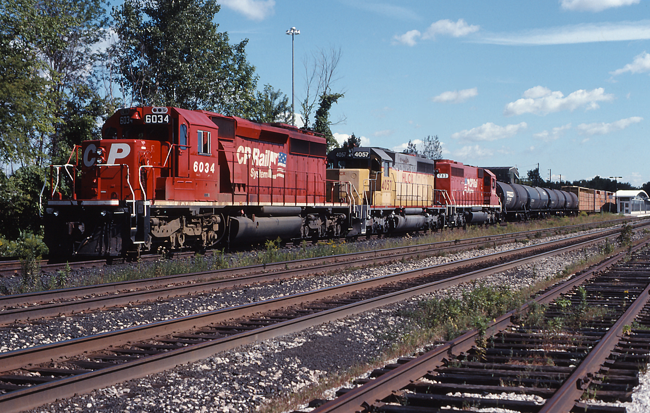 CP 6034, HLCX 4057 and CP 783 sit at Burlington GO station awaiting permission to travel westward to home rails.  Colourful lash ups were common on the CP Rail of the mid-ninties, and today was no exception!
