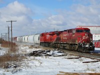 CP 9646 leading CP 9373 kicks up fresh snow on the first day of febuary as they pass through tilbury with the wave from the engineer.