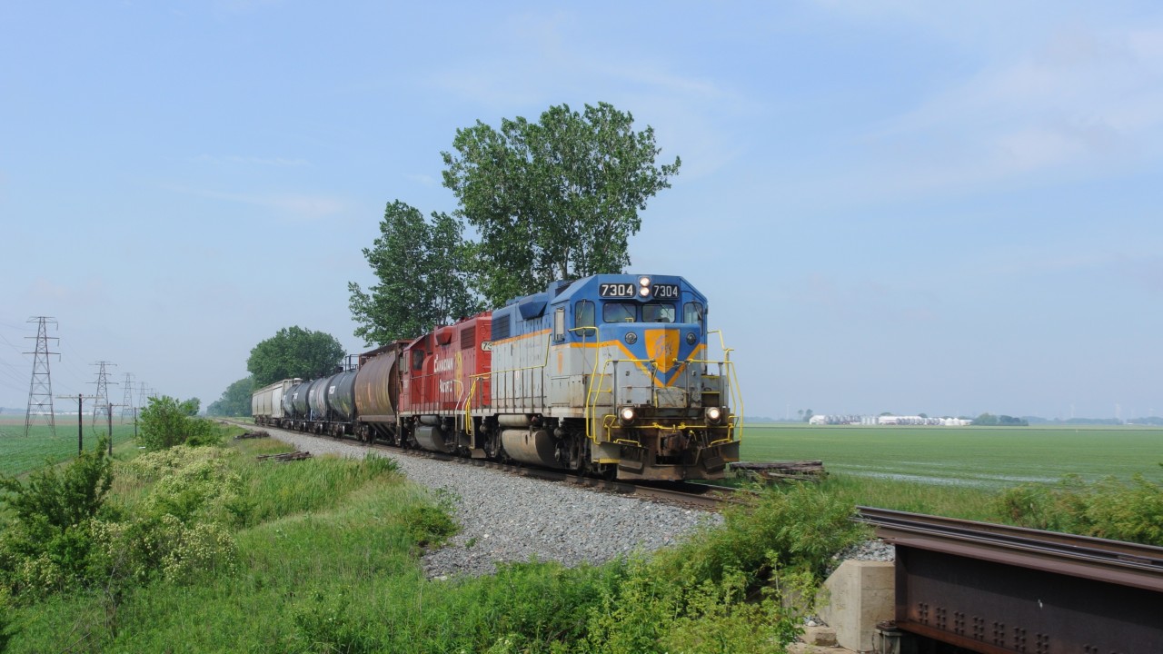 Leading CP T29 (formerly T76)is CP 7304 still baring its D&H paint scheme. The water laying in the track side feild prove that the spring of 2013 has been hard for farmers but Mazex seed in the background has been making good money selling seed to farmers to replant.