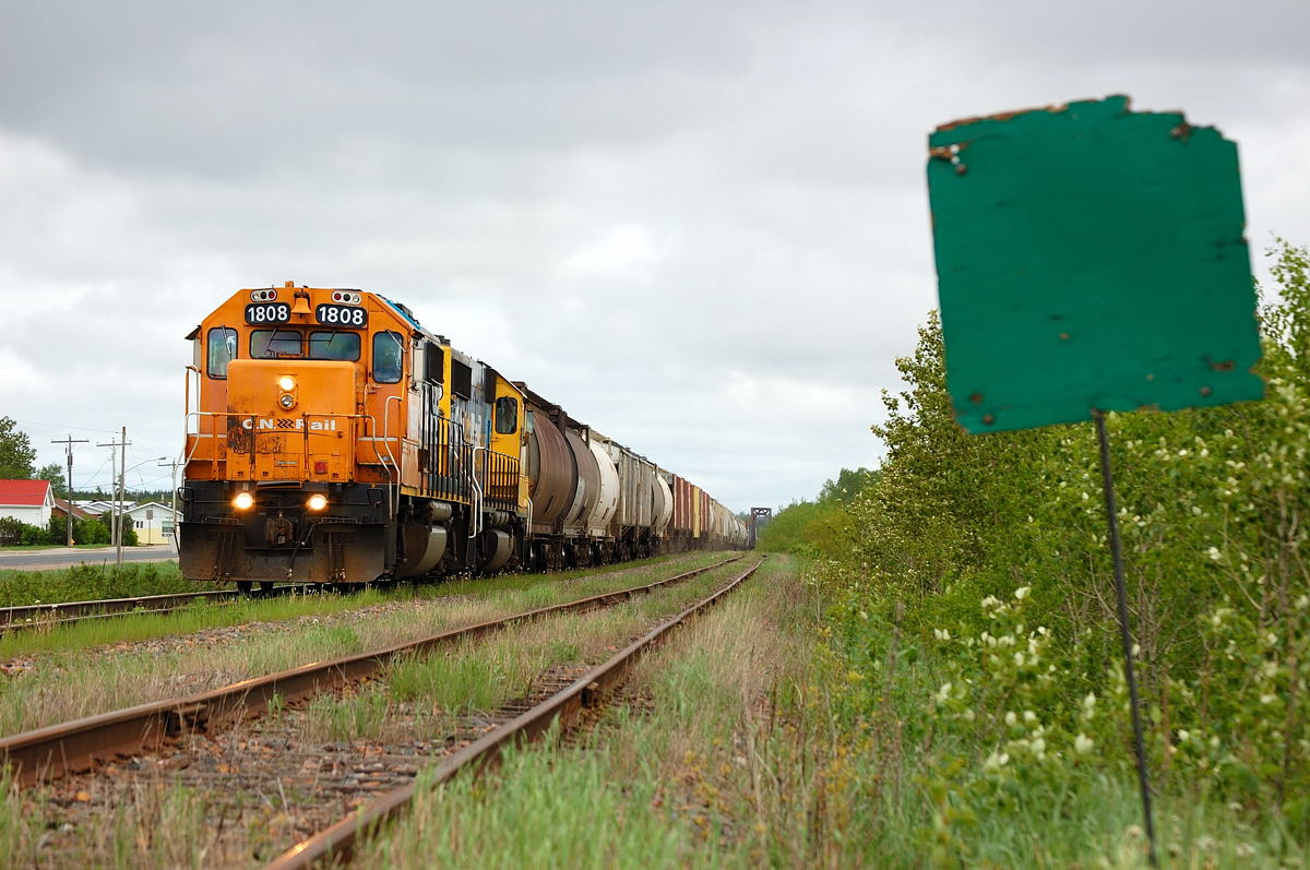 Work 1808 returns west to Hearst with the Agrium Turn. Loaded with potash in tow as they begin to traverse a slow order at Opasatika.