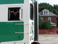 <b><i>Who can it beeeeee now?</i></b><br><br>The shenanigans kick into high gear as one of the GO crew on #281 spots the photographer, at the end of the train's run in downtown Brampton. In the background is one of the 19th century houses built around the time the railway was constructed through town, before anyone ever heard of GO Trains, commuting, Junior Birdman, and Men at Work.