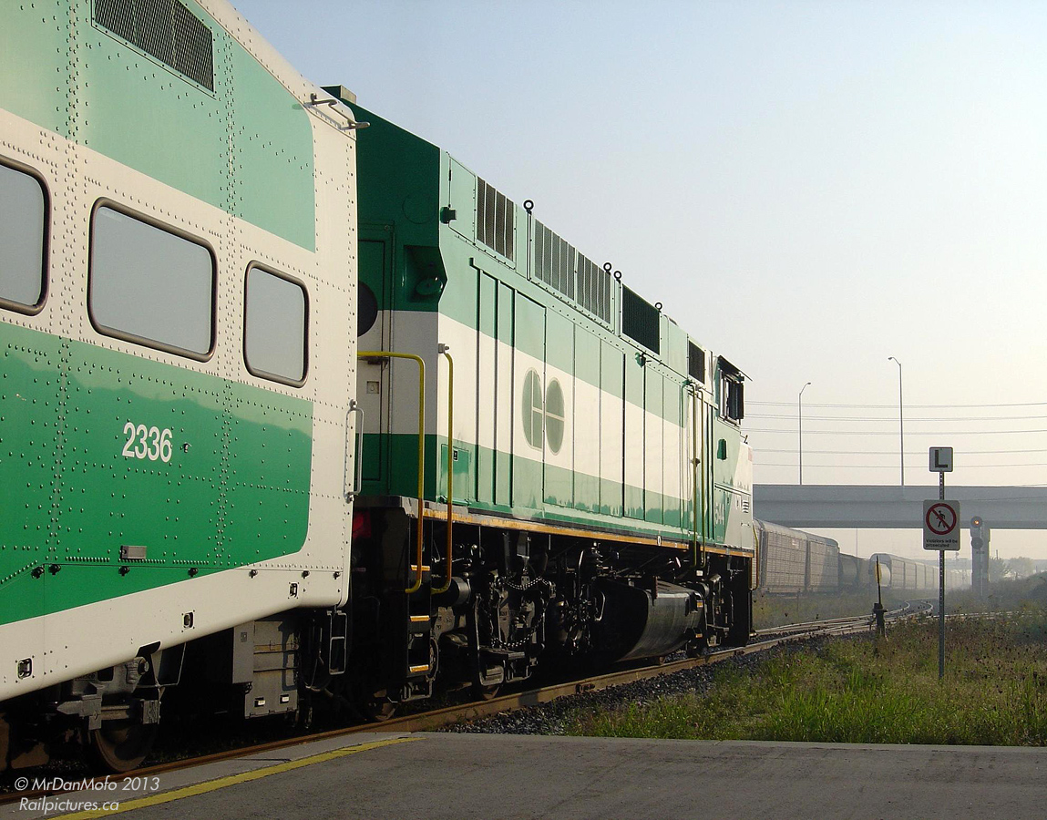 On a hazy morning in the suburbs, GO #252, otherwise known as the 9:05 from Bramalea to Toronto, waits on the commuter track while the minutes tick down to departure. F59PH 544 sits in the lead for the trip east, looking on as a westbound CN freight passes through the station. Upon boarding GO coach 2336, we're greeted with an empty car all to ourselves: the few late morning commuters rarely walked down the platforms from the main stairways.