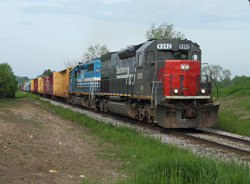 A late running GEXR 432, with the ex Southern Pacific tunnel motor in charge, follows VIA 84 westward out of Kitchener.