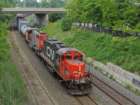 CN 554 passes through the later part of the 2013 Bayview Meet. Some of the railfans that were occupied with the BBQ watch the action from behind the fence. 