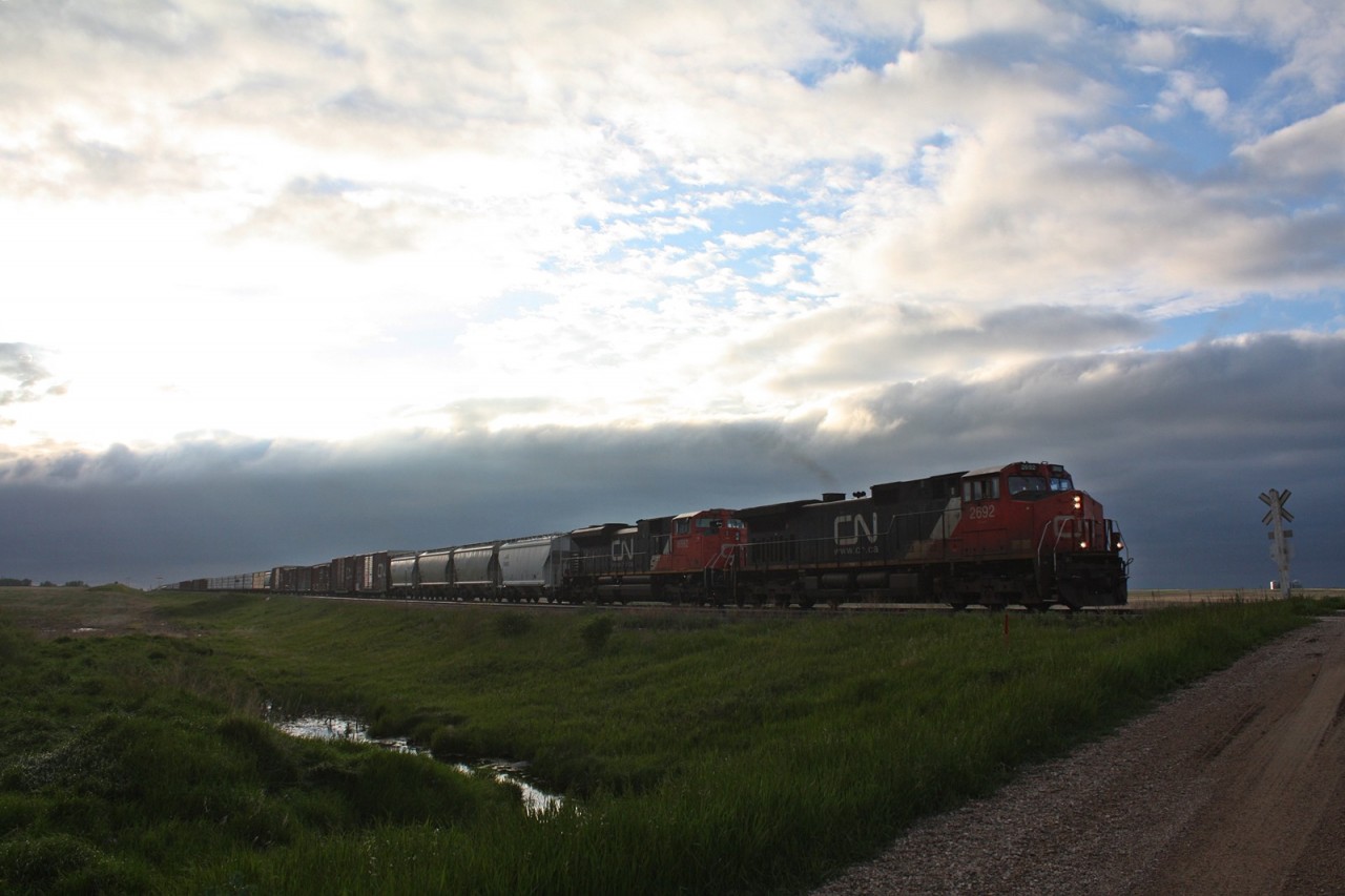CN 2692 with 304 is about to pass 313 at Watrous as the sky does its thing in North Central Saskatchewan.