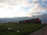 CN 2692 with 304 is about to pass 313 at Watrous as the sky does its thing in North Central Saskatchewan. 