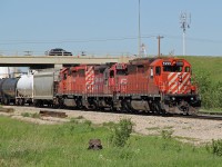 SD40-2's CP 5999 and 6033 bracket GP9 1562 as they head a transfer from CN's Clover Bar Yard back to the CP tracks of the Scotford Sub.