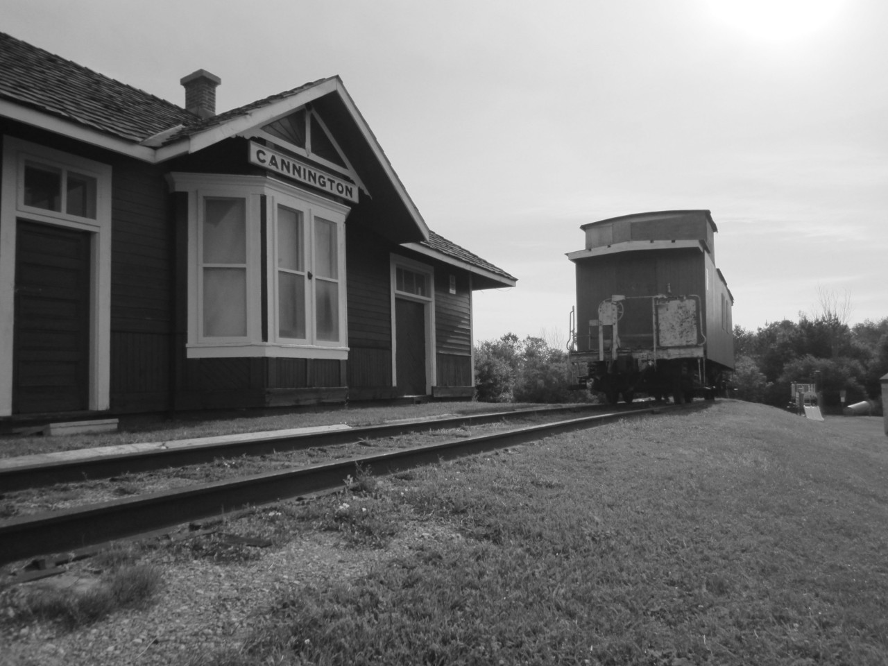 The former Mount Albert station and caboose 78661 rest on a quiet morning.