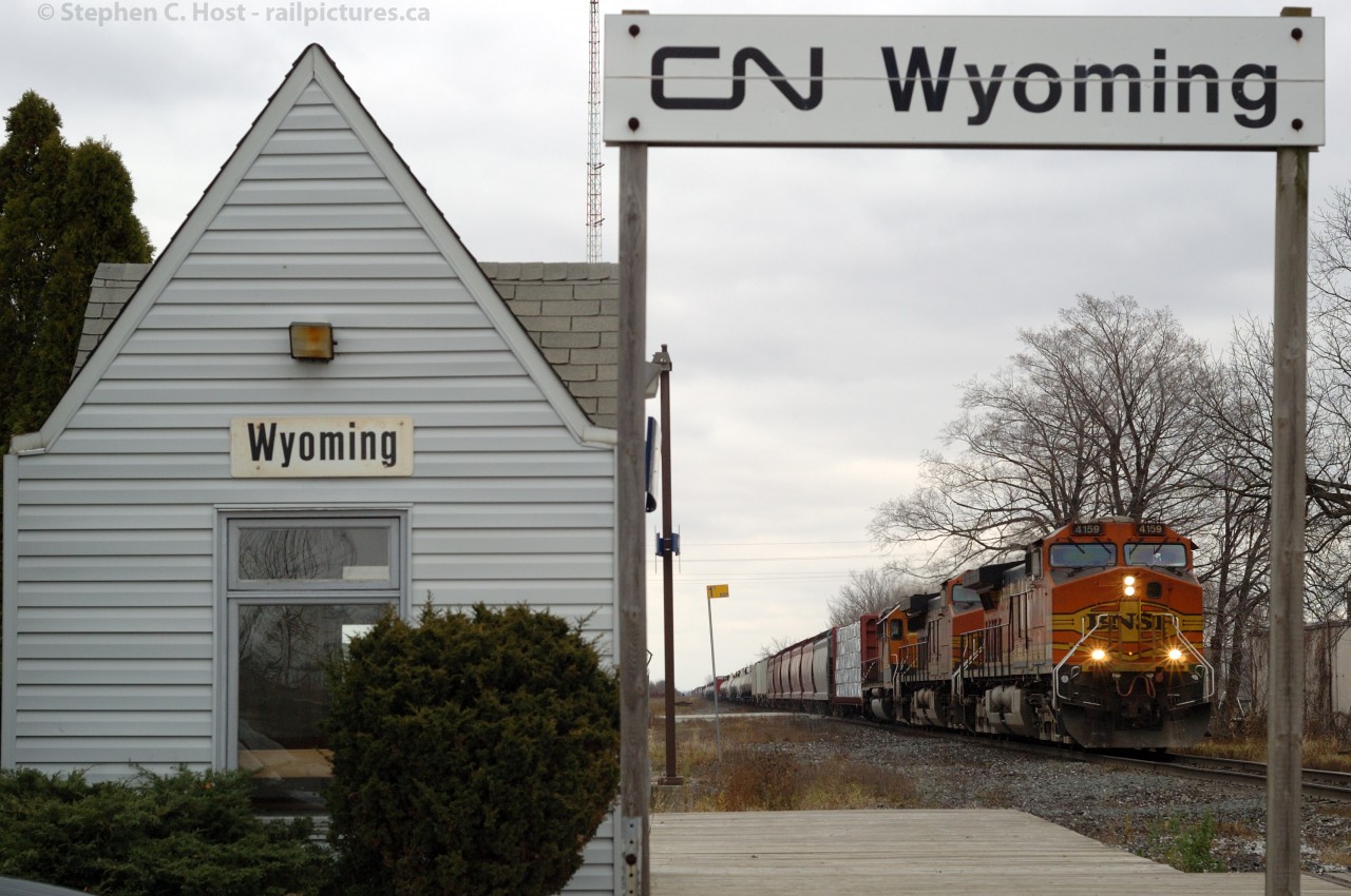 BNSF power leads CN Train 391 by the diminutive station at Wyoming - ultimately a flag stop. This was one of about six Foreign Power consists for the day, how times have changed.
 For a log of the Foreign Power for the day, see this entry by Rob Eull: 
http://finance.groups.yahoo.com/group/FPON/message/2550