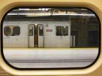 <b><i>Reframed.</i></b> <br><br> Working the rush hour shift when extra trains are put online to handle the evening crowds, a pair of H5 subway trains pause at Downsview Subway Station after completing their runs. Car 5734 is framed in the window of sister 5806, as the chimes sound and doors close before departure. In a few minutes, 5806 (with the downtown-bound photographer aboard) will follow 5734's set on the trip down to Union, up the Yonge line, and eventually to Finch. <br><br> At the time this photo was taken, the first and only new Toronto Rocket trainset on the property was still undergoing testing and training, and the 1970's vintage Hawker Siddeley H5 cars had the run of the mill on the Yonge-University-Spadina line with the newer Bombardier T1 cars. A little over two years later, the last stragglers of the once numerous 138 car H5 fleet, relegated to mostly rush-hour service, would be retired: some to be cut up for scrap and others to be refurbished for service overseas. <br><br> <b><u>More H5 Memories:</u></b><br> At Finch: <a href=http://www.railpictures.ca/?attachment_id=10050>http://www.railpictures.ca/?attachment_id=10050</a><br> At Museum: <a href=http://www.railpictures.ca/?attachment_id=2765>http://www.railpictures.ca/?attachment_id=2765</a><br> At Yorkdale: <a href=http://www.railpictures.ca/?attachment_id=816>http://www.railpictures.ca/?attachment_id=816</a><br> At Bloor: <a href=http://www.railpictures.ca/?attachment_id=817>http://www.railpictures.ca/?attachment_id=817</a><br> At the scrapyard: <a href=http://www.railpictures.ca/?attachment_id=7336>http://www.railpictures.ca/?attachment_id=7336</a>