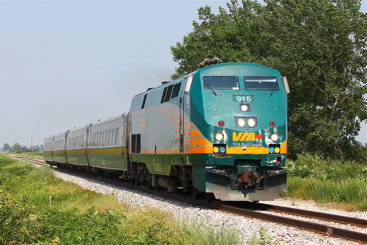On a blazing hot June day VIA 73 blasts it's K5LA horn for Poppe Rd. just east of Jeanette's Creek. P42DC 915 is looking decent (although worn) in her new(ish) paint after her run-in with a pick up truck a few years ago near Glencoe. I captured the unit just after it was re-railed and during it's wheel change out in Chatham, it had extensive cosmetic damage to the cab and pilot.