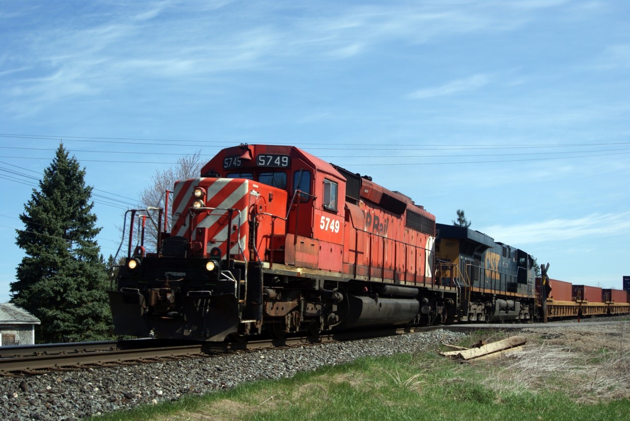 CP SD40-2 5749 along with CSXT ES44DC 5201, lean into the curve through Innerkip, enroute to the crew change point of London, Ontario.