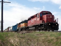 CPR Dual Flag image SD40-2 6066, leads a former BNSF, now Helm SD40-2 8033 on an eastbound manifest at the 43rd Line crossing, on the Galt Sub.