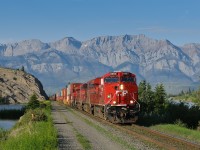 Detouring due to severe washouts on CP's Laggan Subdivsion in central Alberta, CP Train 101-17 (running as CN train F40151 21 between East Edmonton, AB and Coho, BC) speeds west on the most scenic part of CN's Edson Subdivision. The train consisted of CP ES44AC 8907, AC4400CW 9775, ES44ACs 8711 and 8755 on the headend, followed by 93 intermodal platforms, AC4400CW 9683 mid-train with another 43 intermodal platforms behind that. A real rocket traveling on their bosses former turf!