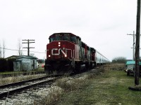 While all the interest earlier this year, had the light on the CASO's final days as the rail was removed. In 2002, silently reality slipped away from the once great speedway's east end. Admittedly, without a lot of hype or fanfare.

Used for the longest time, to store NCIX plastic pellet hoppers, the time had come. The final run to grab the hoppers so the rail could be removed. This was the run, a gloomy April day, no railfan hype, no fanfare. Just 2 CN GP's and a string of those hoppers. Appropriately 9606's class lights are on, normally for the end of a train, this time, the beginning of the end for the once great Canada Southern.
